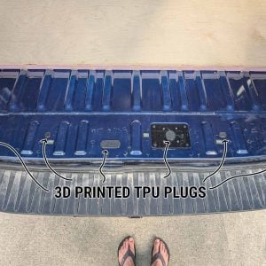 Arrows marking 3D printed TPU plugs filling holes in the rear floor sill