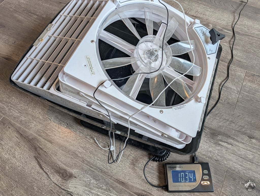 Maxxfan Deluxe roof fan on a digital scale reading 10.34 lb